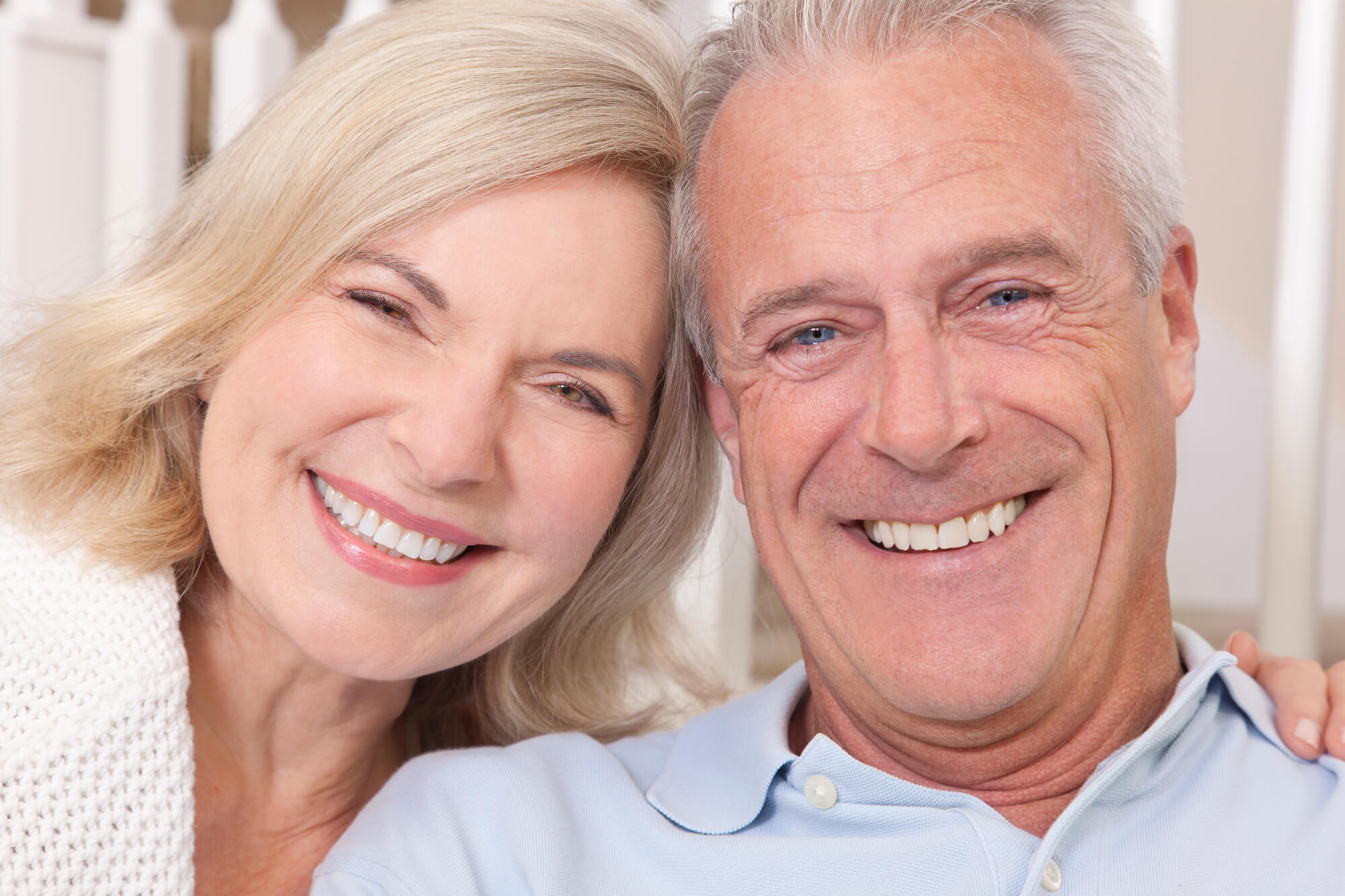 happy senior couple showing off their dental implants in New Smyrna Beach