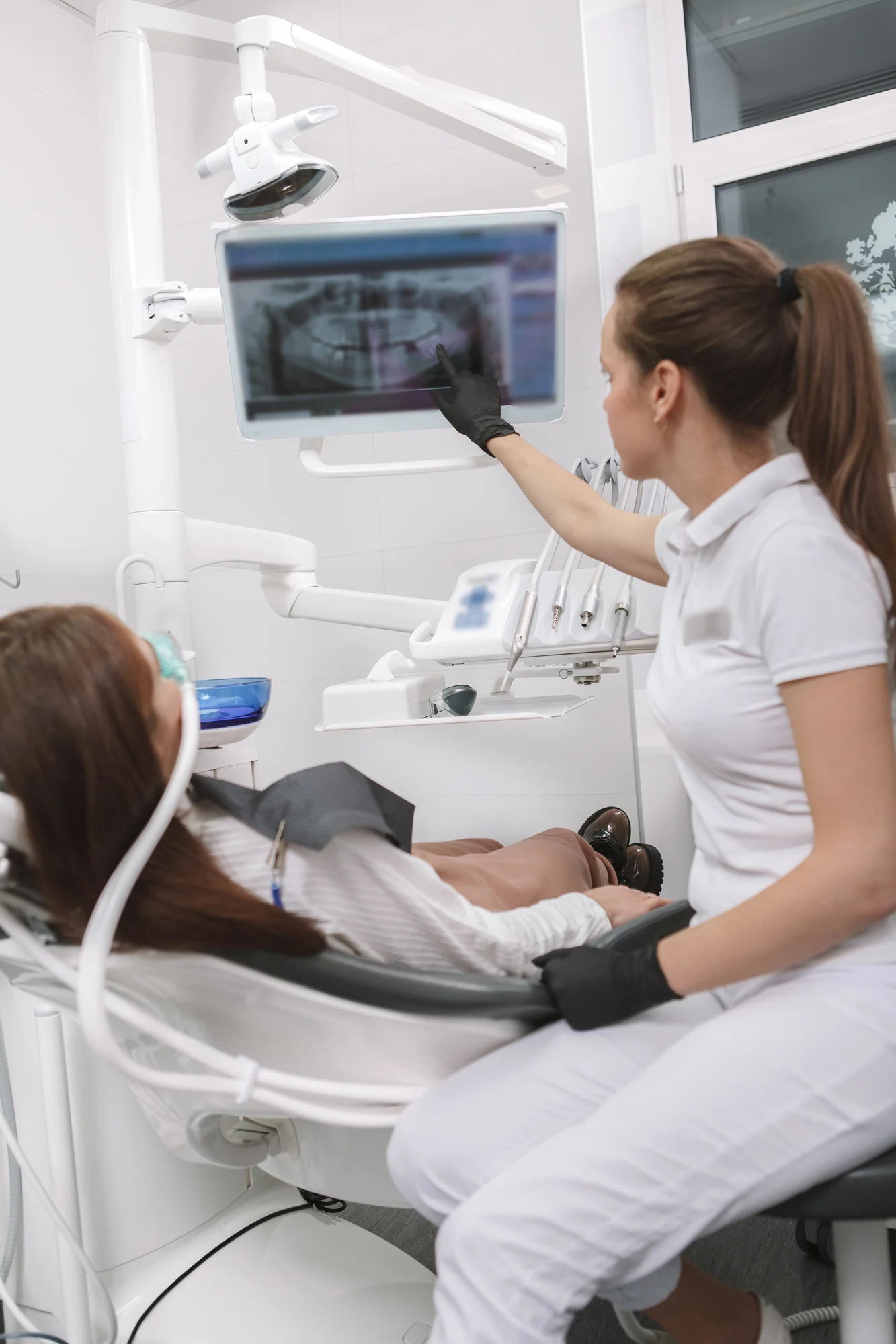 Dentist reviewing mages during comprehensive dental care in New Smyrna Beach