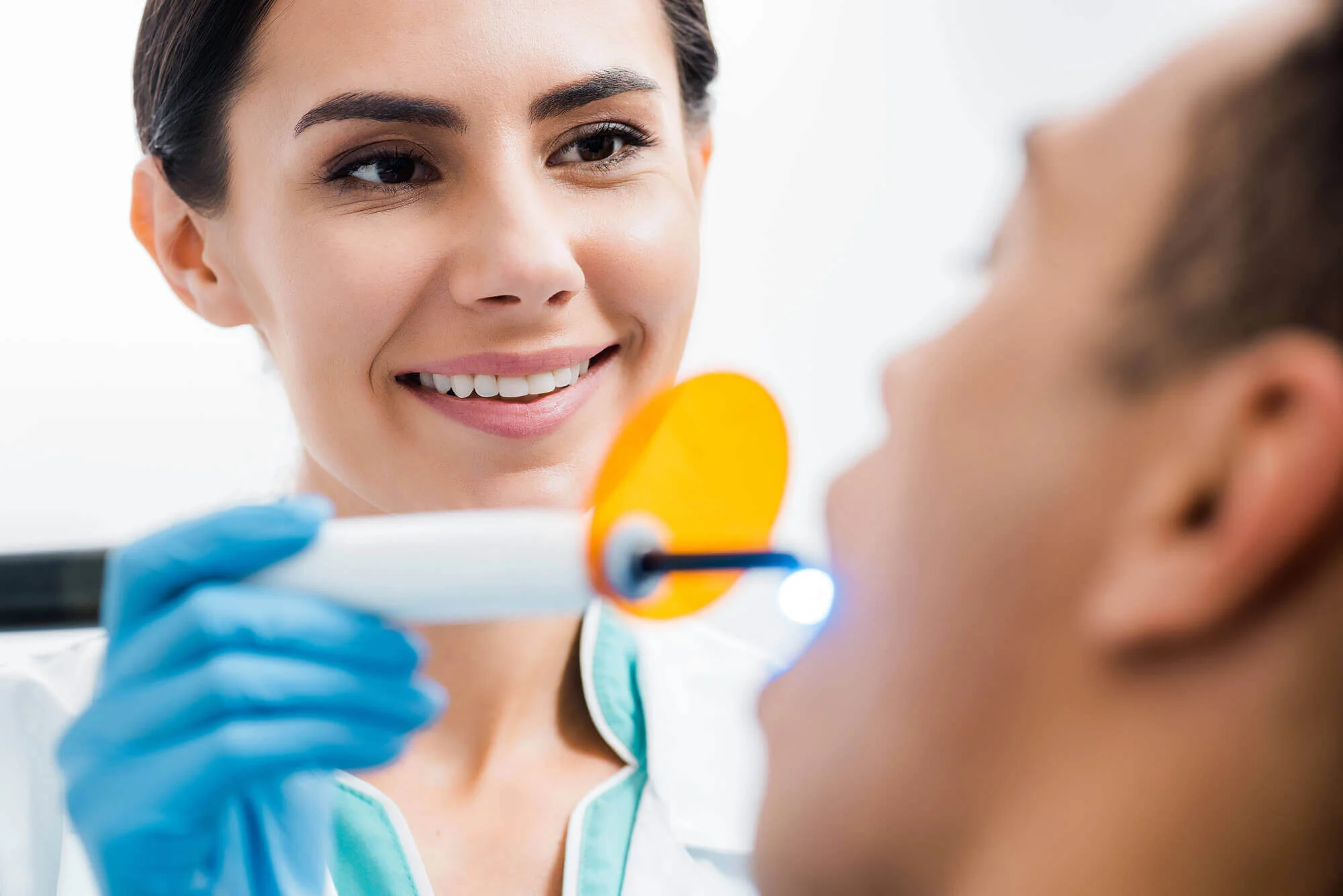 Dental hygienist cleaning patient’s teeth dentist in Upper West Side